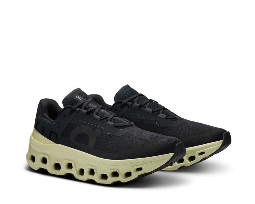 On Cloudmonster Black/Acacia side view — maximum cushioning profile men